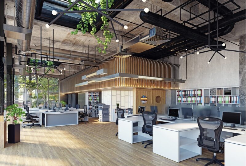 Nave de oficina de perfil industrial con estructura y ductos a la vista